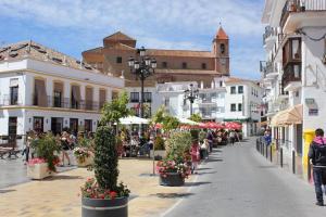 a street in a town with people sitting at tables at Torrox Pueblo Hidden Gem, 2 Bed Apartment in Torrox
