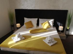a large bed with towels and pillows on it at Hotel Bor in Krk