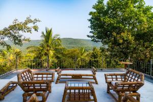 a patio with chairs and a table with a view at Private Terrace Room with the most scenic views in Alibaug