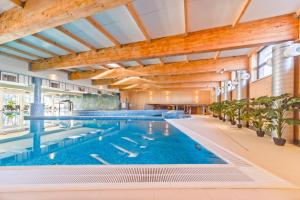 a large swimming pool in a large building at River Style Hotel & SPA in Reda
