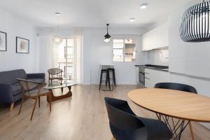 a kitchen and dining room with a table and chairs at ApartUP Port Area I in Valencia