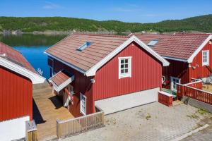 einen Blick über ein rotes Gebäude mit einem Dock in der Unterkunft Feriehus ved Saltstraumen in Bodø