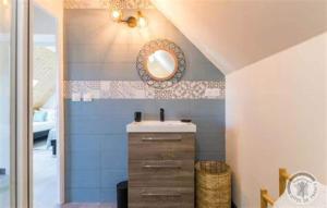 a bathroom with a sink and a mirror at L'Âme du Gourmand in Pontorson