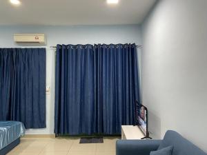 a living room with blue curtains and a couch at CQ28-SELF CHECK IN- Wifi- Netflix- Parking-New, 2017 in Cyberjaya