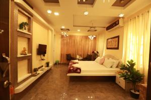 a bedroom with a white bed in a room at Villa Residency in Navi Mumbai