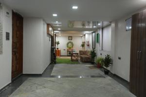 a hallway with a door and a living room at Villa Residency in Navi Mumbai