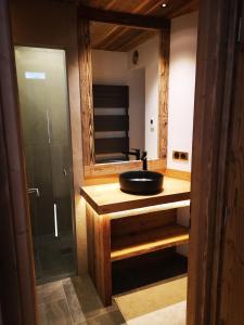 a bathroom with a sink and a glass shower at Tignes Val Claret - Beau T3 de standing, refait à neuf in Tignes