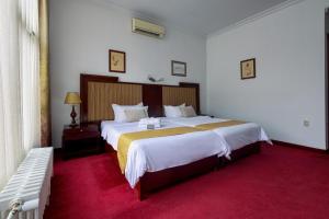 Postel nebo postele na pokoji v ubytování Garni Hotel Planeta Inn