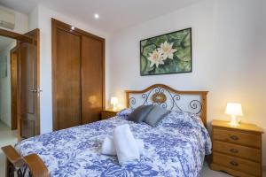a bedroom with a blue and white bed with two pillows at Villa Playera in Alcudia +25 photos