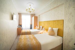 Postel nebo postele na pokoji v ubytování Miran Hotel