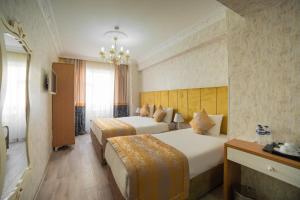 Postel nebo postele na pokoji v ubytování Miran Hotel