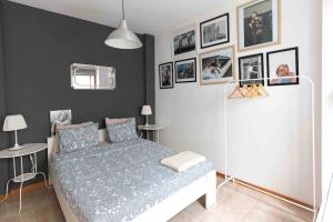 a bedroom with a bed and pictures on the wall at Atlantic Flat - Acogedor piso en Vegueta, Las Palmas in Las Palmas de Gran Canaria