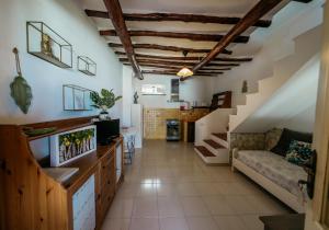 a living room with a staircase and a couch at Case Vacanza Cafarella in Malfa