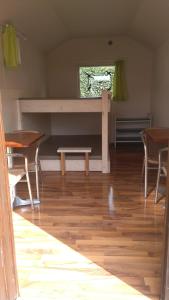 a room with wooden floors and a table and chairs at Treene Camp Horn in Esperstoft