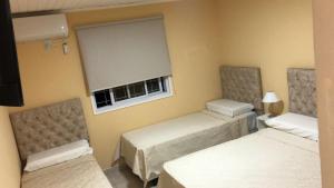 a hotel room with two beds and a window at Sol Latino 2 in Victorica
