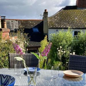 a table with wine glasses on top of it at Kelvin House - Cawsand in Cawsand