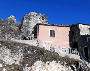 a building on the side of a hill with a castle at Il Castello in Viggiano