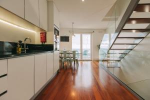 an open kitchen and dining room with a glass floor at Ocean View by Azores Villas in Ponta Delgada
