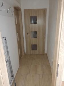 a hallway with a wooden door in a room at Apartmán Petra in Kovářská