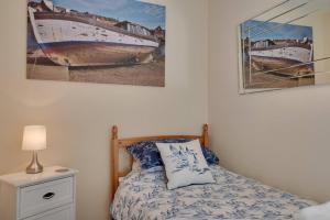 a bedroom with a bed and two paintings on the wall at Abbey View Bagdale in the Centre of Whitby in Whitby