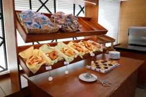 a table with baskets of bread and pastries at Park Inn by Radisson Istanbul Asia Kavacik in Istanbul