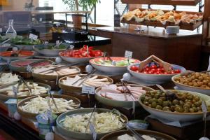 a buffet filled with different types of food in bowls at Park Inn by Radisson Istanbul Asia Kavacik in Istanbul