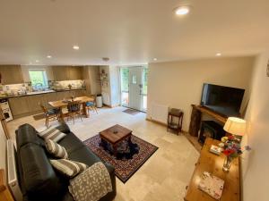 a large living room with a couch and a table at Bamford Barn in Ottery Saint Mary