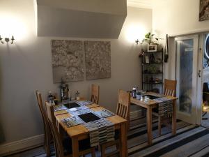 a dining room with a wooden table and chairs at St Michael's Guest House in Scarborough +104 photos
