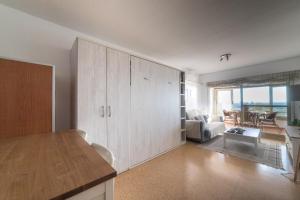 a living room with a large cupboard and a living room at Moonkey - Estudio Las Lanzas in El Campello
