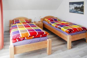 two beds sitting next to each other in a room at Semi-detached house Rügentraum, Glowe in Glowe