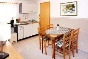 a kitchen and dining room with a table and chairs at Apartment, Lohme in Lohme