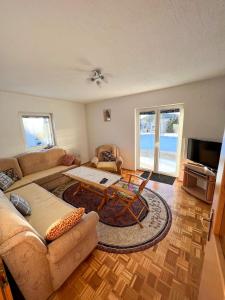 a living room with a couch and a table at Kuća Vesna in Kupres