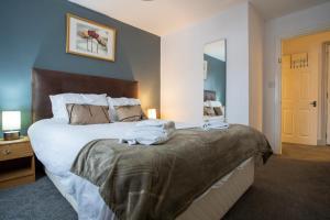 a bedroom with a bed with towels on it at Denecroft apartments in Lynemouth