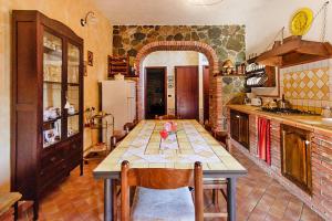 a kitchen with a table in the middle of a room at Holiday home, Francavilla di Sicilia in Francavilla di Sicilia