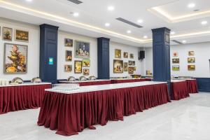 a row of tables in a room with red curtains at Macara Lake Park in Quba +107 photos
