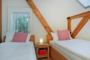 two twin beds in a room with a window at Apartment in Garz with parking space in Garz-Rügen