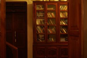 a book shelf with books in it next to a door at Vanilla County Heritage Plantation Bungalow in Vagamon