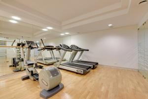 a gym with several tread machines in a room at Waterlane Riverside - SPA, Pool, Gym & Parking by Downtown Apartments in Gdańsk