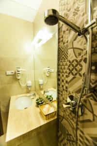 a bathroom with a sink and a shower at Business Class Apartment in Cluj-Napoca