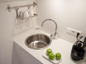 a kitchen with a sink and some apples on a counter at Houseboat Volle Maan in Amsterdam