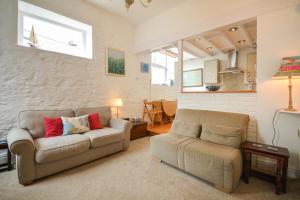 a living room with two chairs and a couch at Rose Cottage - Kingsand in Kingsand