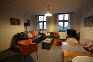 a living room with a couch and a table at Bournemouth Reef Apartment in Bournemouth