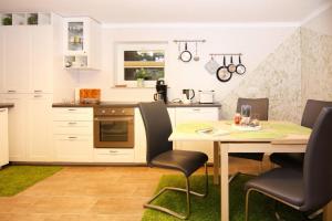 a kitchen with a table and chairs in a room at Ferienwohnung in Dassow in Dassow