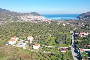 an aerial view of a house on a hill next to the ocean at Liofoto in Skopelos Town