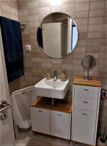 a bathroom with a sink and a mirror and a tub at Aphrodite Studio near Athens Floisvos Marina in Athens