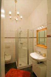 a bathroom with a sink and a shower and a toilet at Low Budget in Bremen