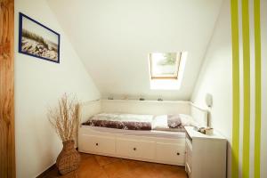 a white room with a bed in a attic at Apartment, Kenz-Küstrow in Kenz