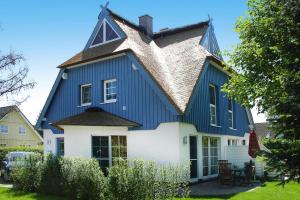 a blue and white house with a gambrel roof at Semi-detached house, Zingst in Zingst