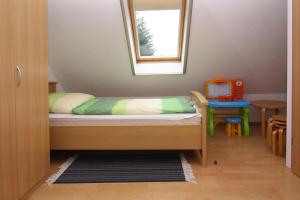 a small bedroom with a bed and a small table at Terraced house, Zingst in Zingst