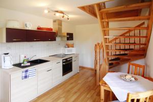 a kitchen with a staircase and a table in a room at Apartment, Wieck am Darss in Wieck
